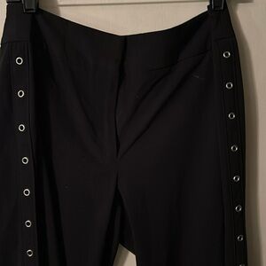Apostrophe-Elongating Silver Metal Circles down the Black Bootleg pants. Sz14.